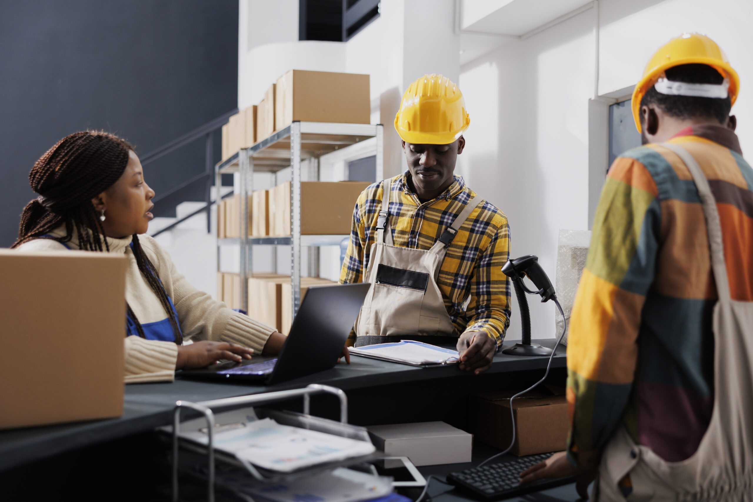 shipment-manager-asking-warehouse-workers-about-merchandise-storage-system-african-american-storehouse-employees-talking-using-inventory-software-laptop-reception-counter