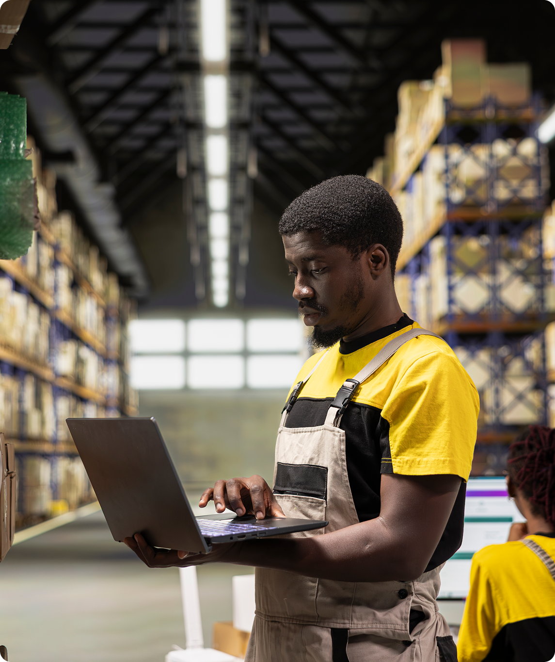 warehouse-technician-inspecting-cargo-details-shelves-large-scale-fulfillment-center 1 Warehouse manager accesses Winfreight's inventory management software reporting and stock performance dashboards on a laptop.